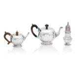 Two bullet style modern silver teapots, and a sugar caster the largest by Garrard & Co, London 2...