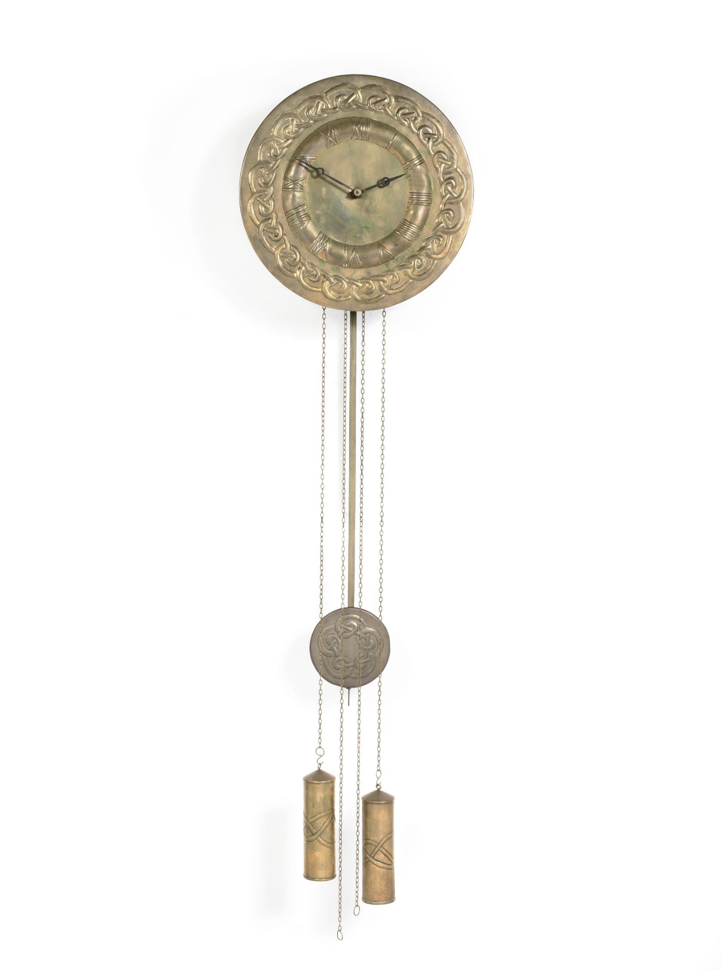 In the Manner of Margaret Gilmour (British, 1863-1942) An Arts & Crafts Repoussé Brass Wall Clock...