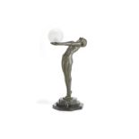 Max le Verrier (French, 1891-1973) Clarté: A Large Art Deco Green Patinated Metal Figural Lamp; m...