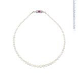A natural pearl necklace with ruby and diamond clasp,