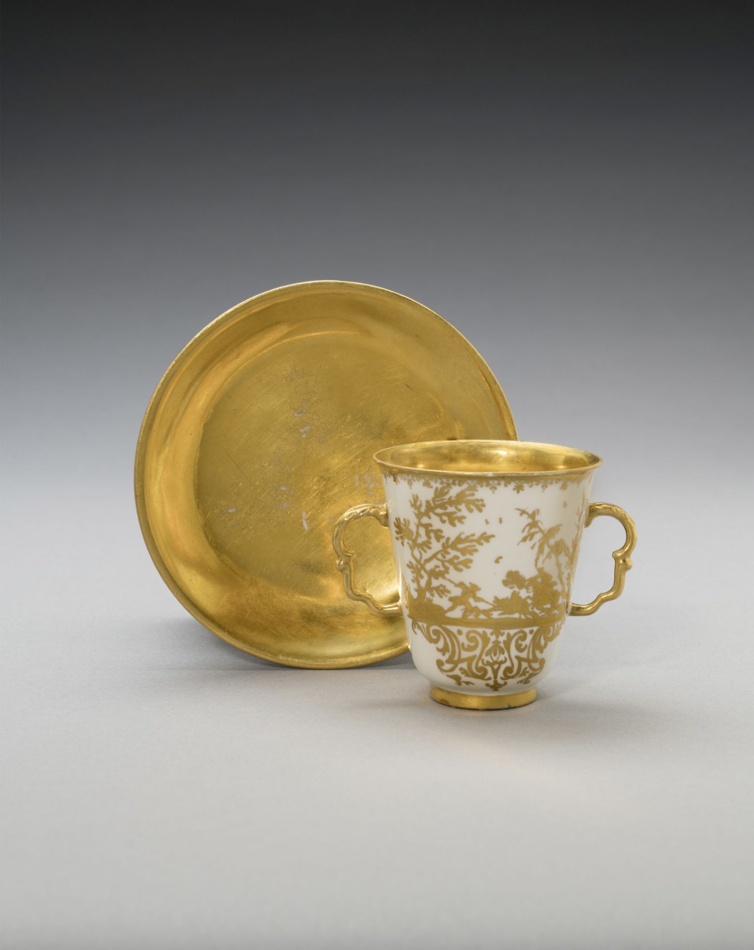 A Meissen Hausmaler double-handled beaker and saucer, circa 1725-30