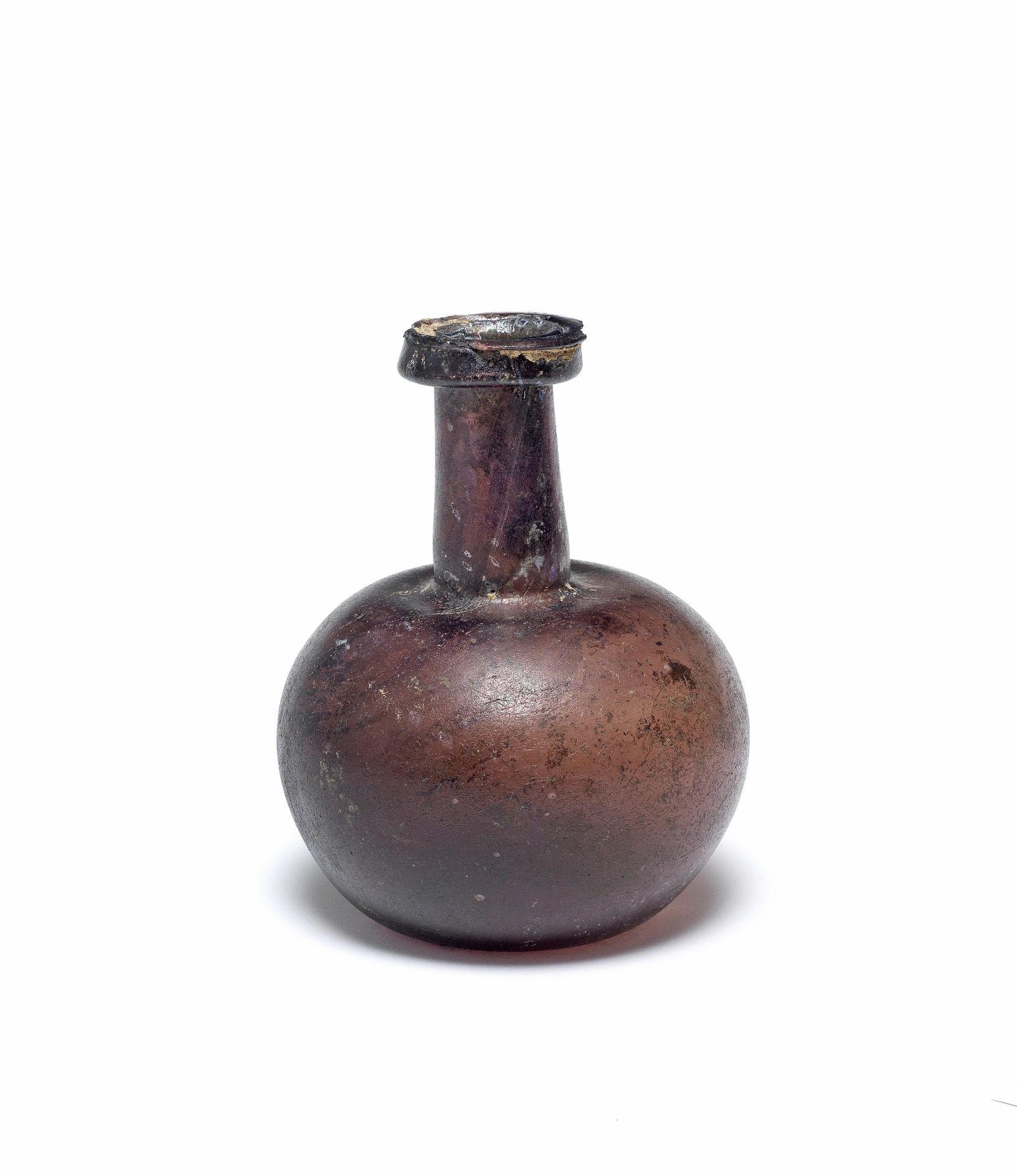 A Roman aubergine glass flask