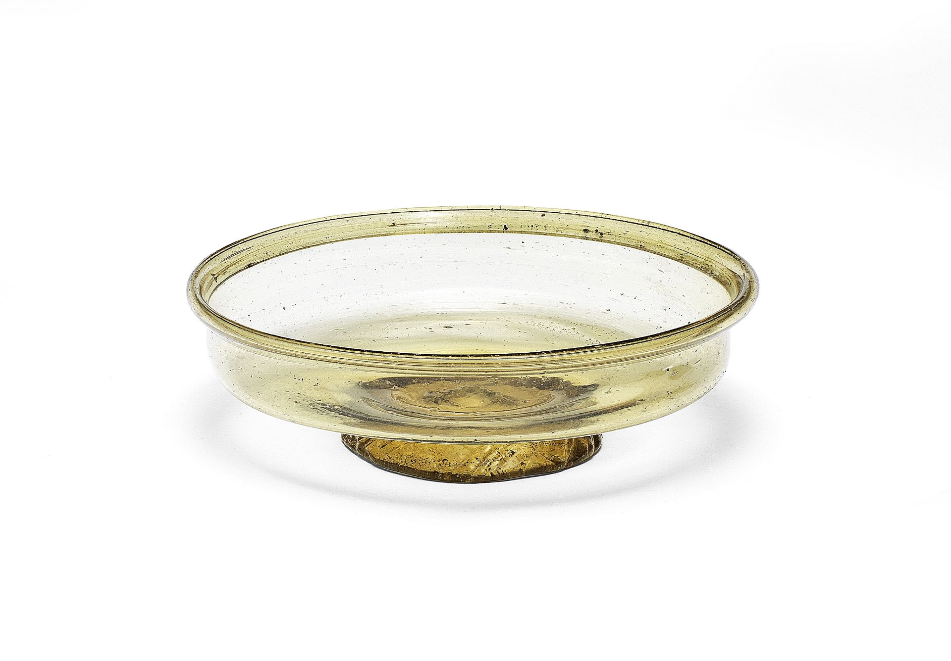 A Roman glass footed bowl