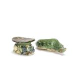 A blue and sancai glazed elbow rest and a green glazed pottery model of a recumbent boar Tang Dyn...