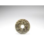 A green and russet jade 'chilong' disc, bi Ming Dynasty