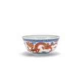 A blue and white, iron red and green enamelled 'dragon' bowl, Cai hua tang zhi iron red mark, 19t...