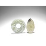 A WHITE AND BLACK JADE 'DRAGON AMONG CLOUDS' PENDANT and a pale green jade 'chilong' bi (2)