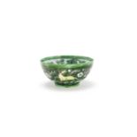 A famille verte biscuit 'celestial horses' bowl Kangxi