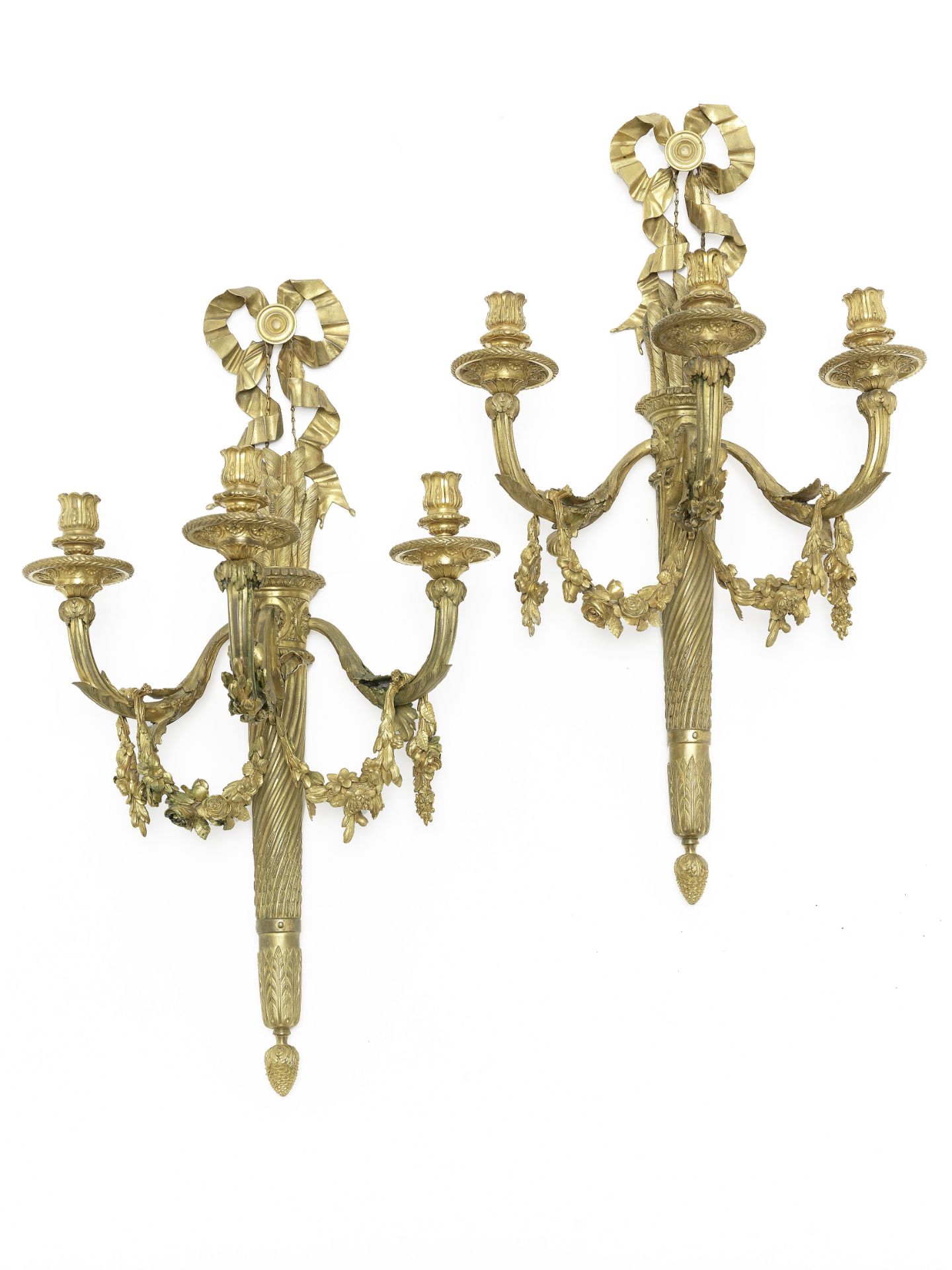 A pair of gilt bronze three-light wall appliques in the Louis XVI style, (2)