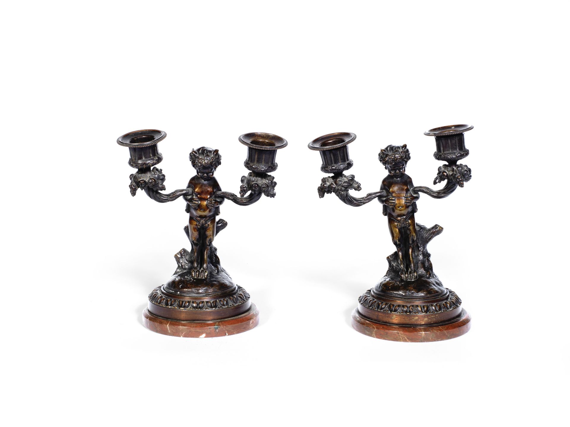 A pair of late 19th century French patinated bronze twin branch dwarf figural candelabra in the ...