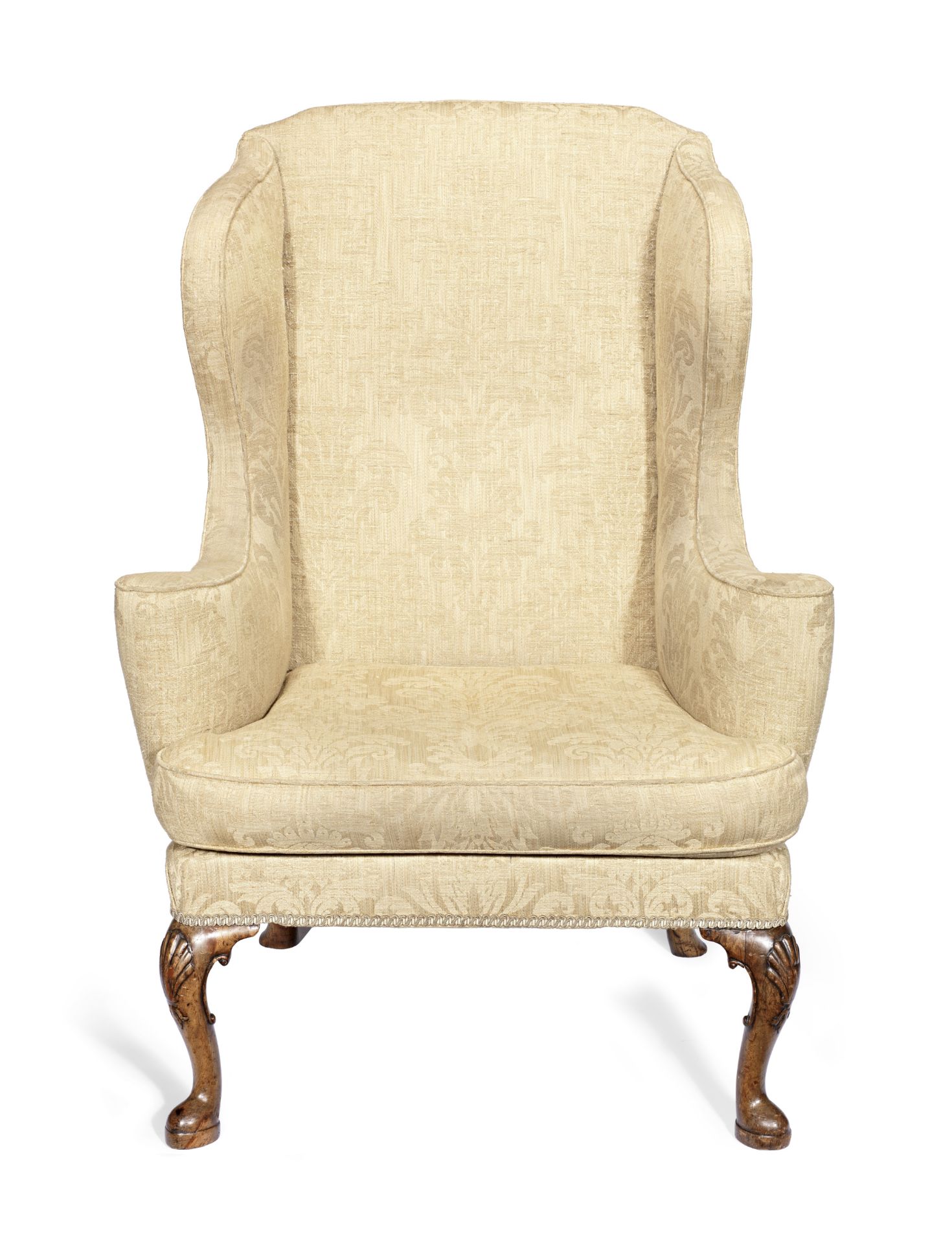 A walnut wingback armchair in the George II style