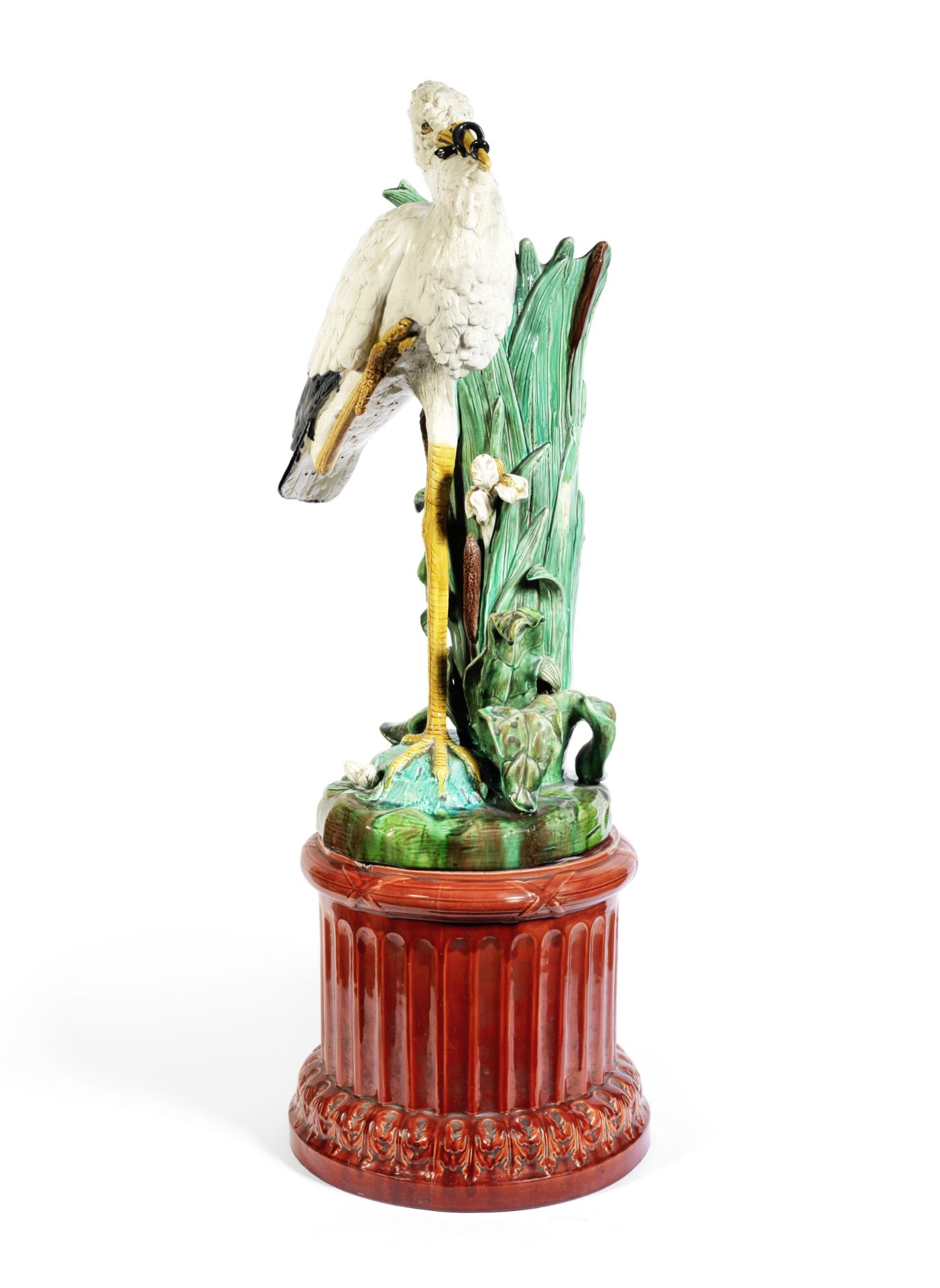 A late 19th century Majolica glazed earthenware stork stick stand and pedestal in the Minton style