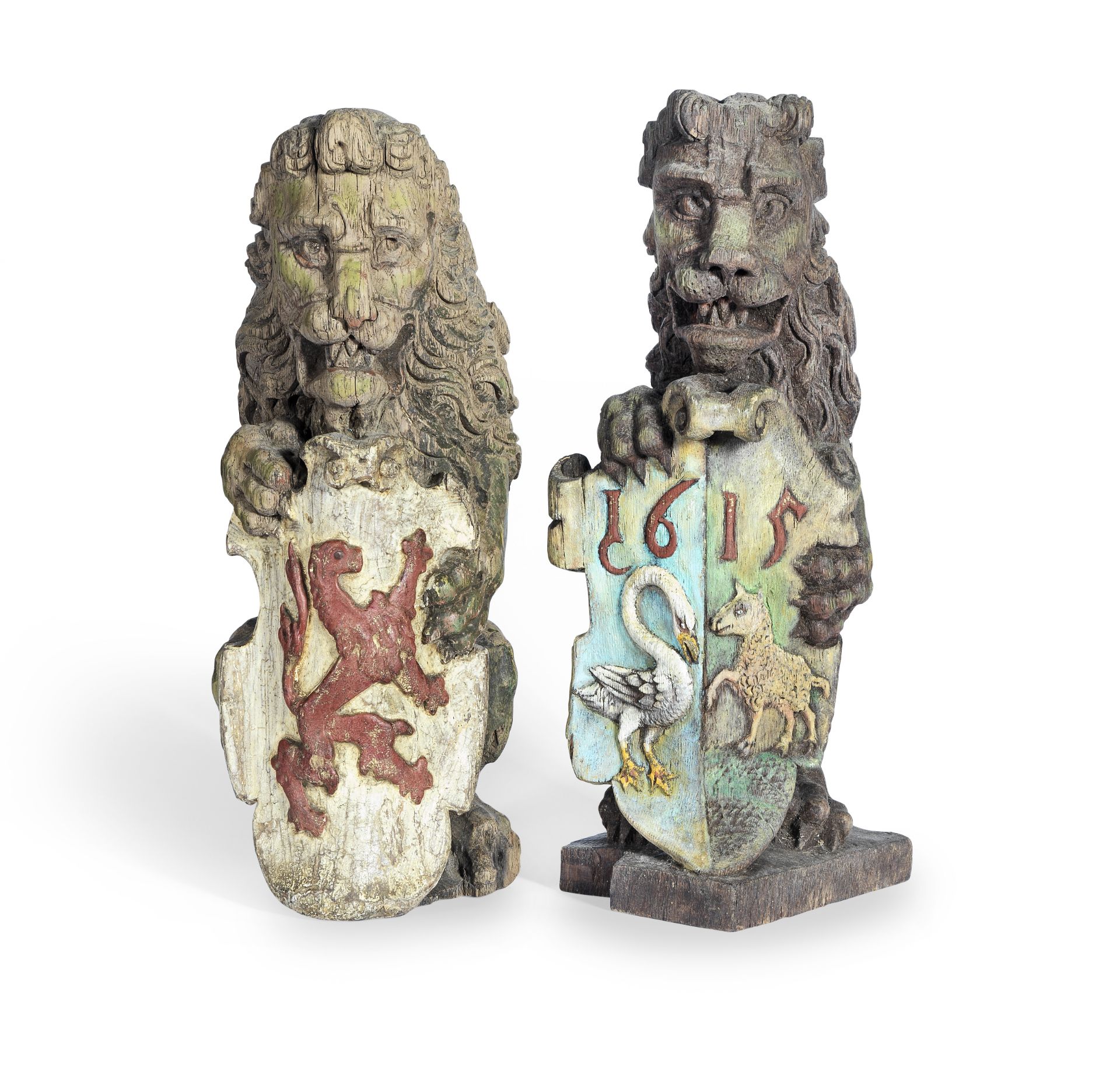 A pair of polychrome painted carved oak heraldic newel finials (2)