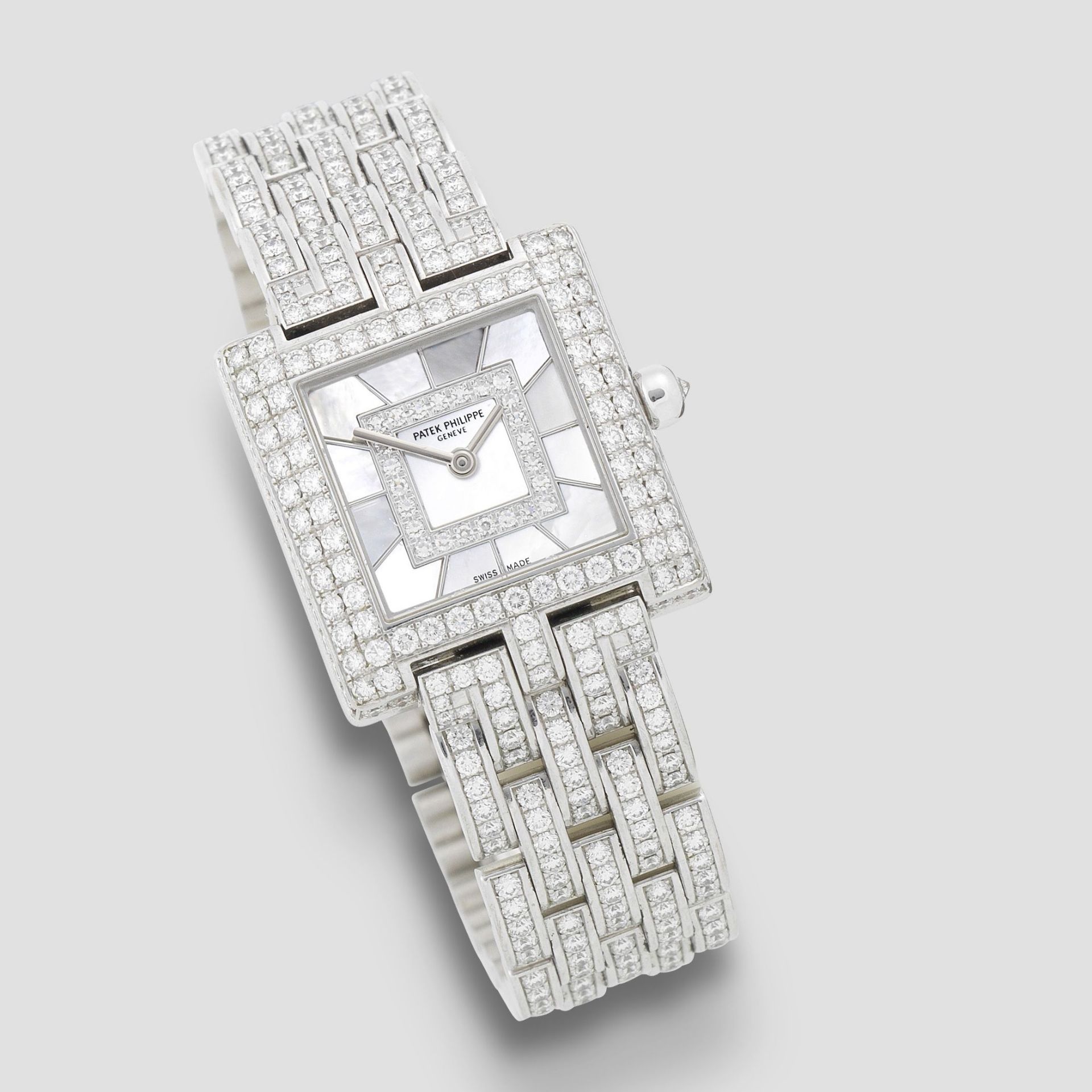Patek Philippe. A lady's fine 18K white gold, diamond set and mother of pearl quartz bracelet wat...