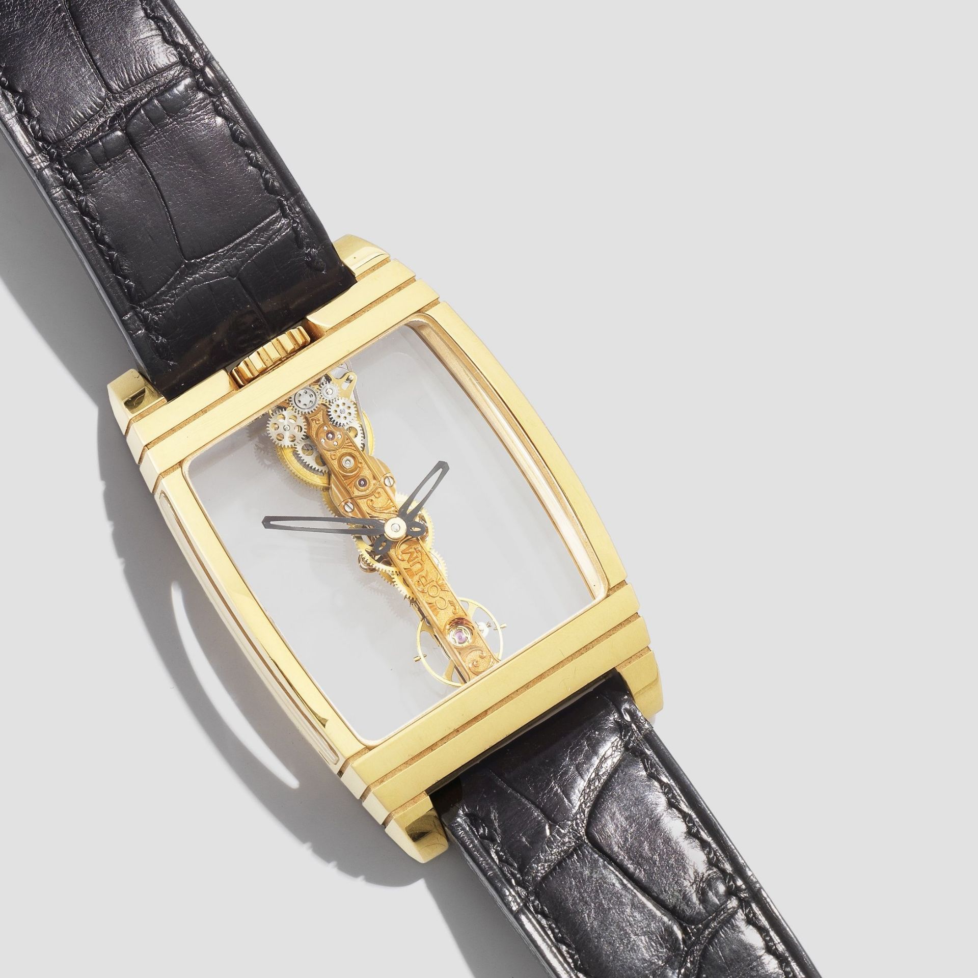 Corum. An unusual 18K gold manual wind wristwatch with visible straight line movement Golden Bri...