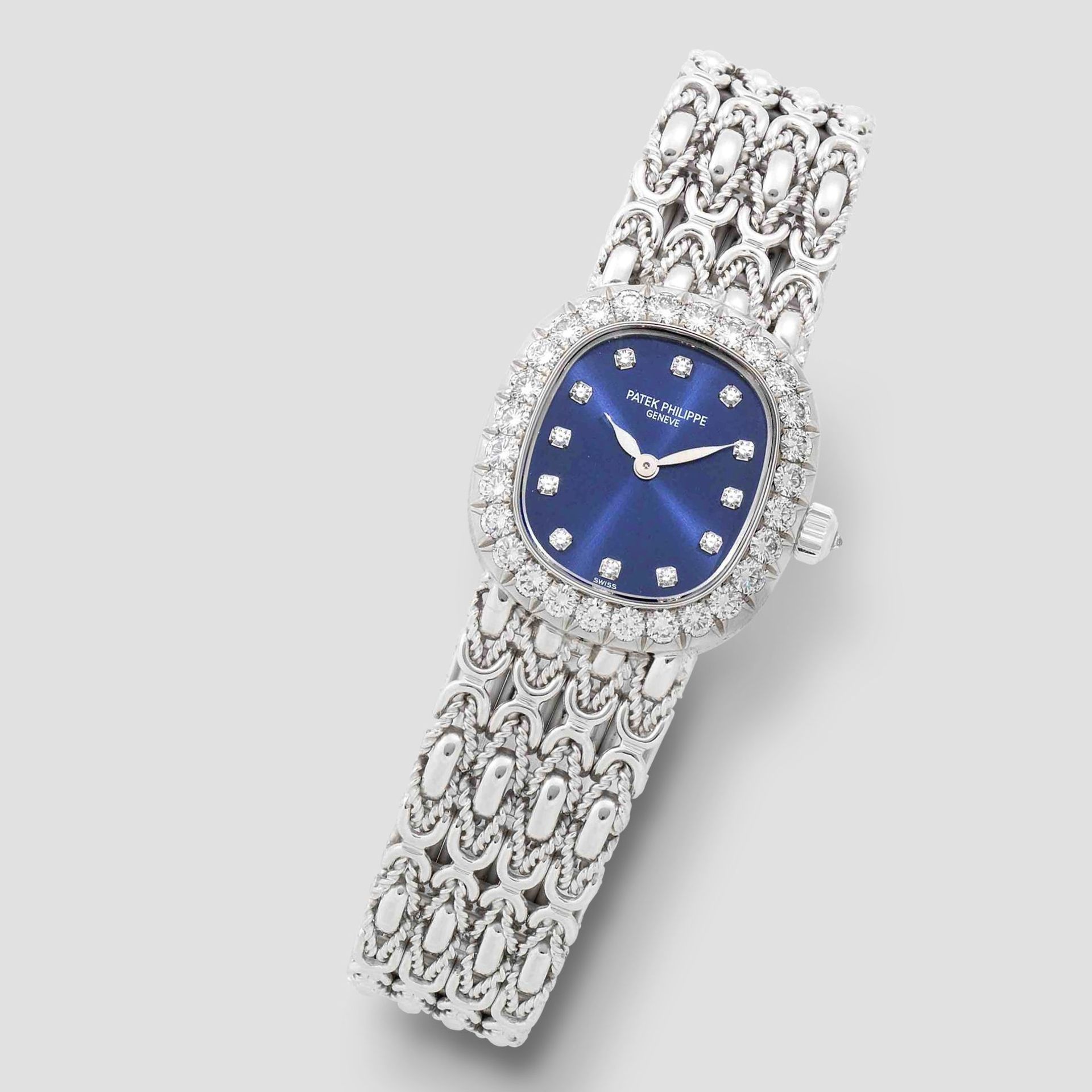 Patek Philippe. A lady's fine 18K white gold and diamond set manual wind bracelet watch Ellipse,...