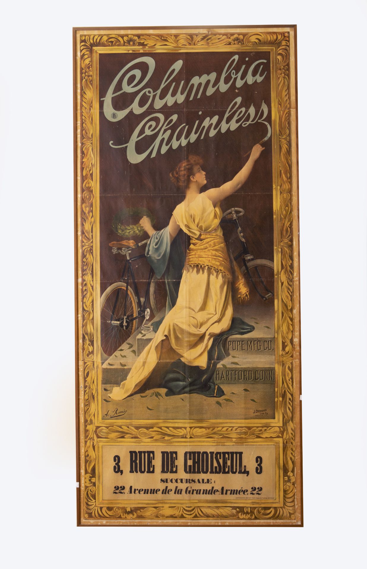 A mounted and framed advertising poster