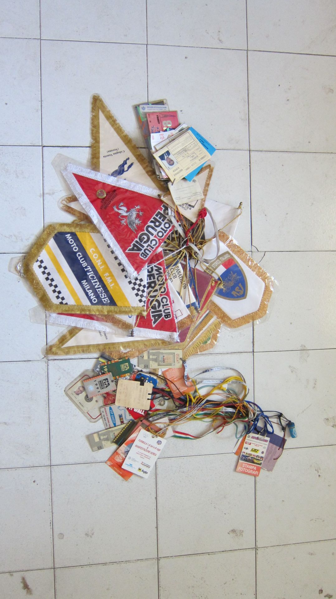 A large quantity of paddock passes and pennants ((Qty))