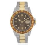 Rolex. A stainless steel and gold automatic calendar bracelet watch with dual time zone GMT Mast...