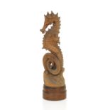 A late 19th/early 20th century carved fruitwood Seahorse