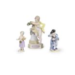 A Meissen figure of a putto, together with two small Meissen figures, late 19th century