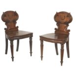 A pair of William IV mahogany hall chairs