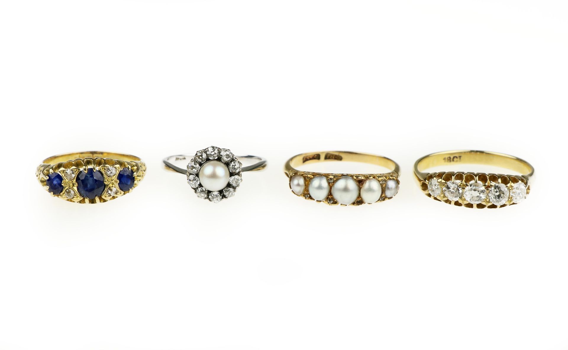 A collection of four gem-set and diamond rings