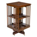 An early 19th century mahogany crossbanded revolving bookcase