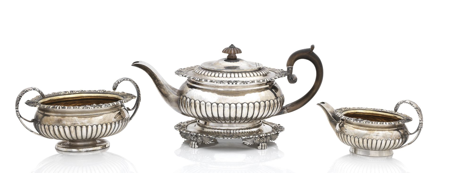 A George III matched silver tea service the teapot and stand by J.E. Terry & Co, London 1817, the...