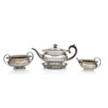 A George III matched silver tea service the teapot and stand by J.E. Terry & Co, London 1817, the...