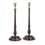 An outsize pair of Victorian mahogany candlesticks