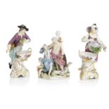 A pair of Berlin figural salts, late 19th century, together with A Meissen group circa 1763-74