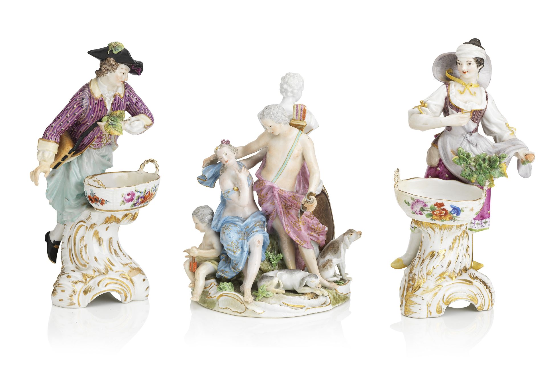 A pair of Berlin figural salts, late 19th century, together with A Meissen group circa 1763-74