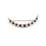 A sapphire and diamond crescent brooch