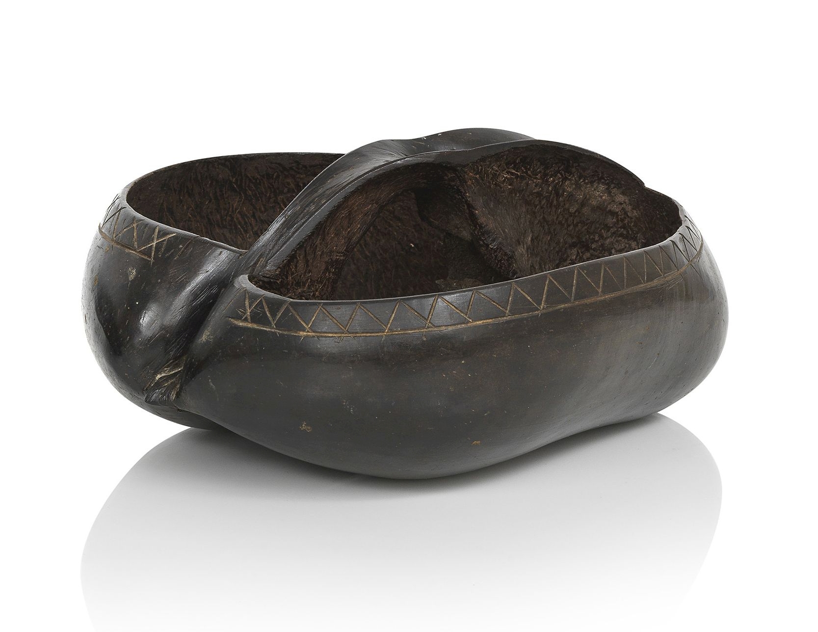 A carved and polished Coco de Mer nutshell (Lodoicea Maldivica) formed as a basket