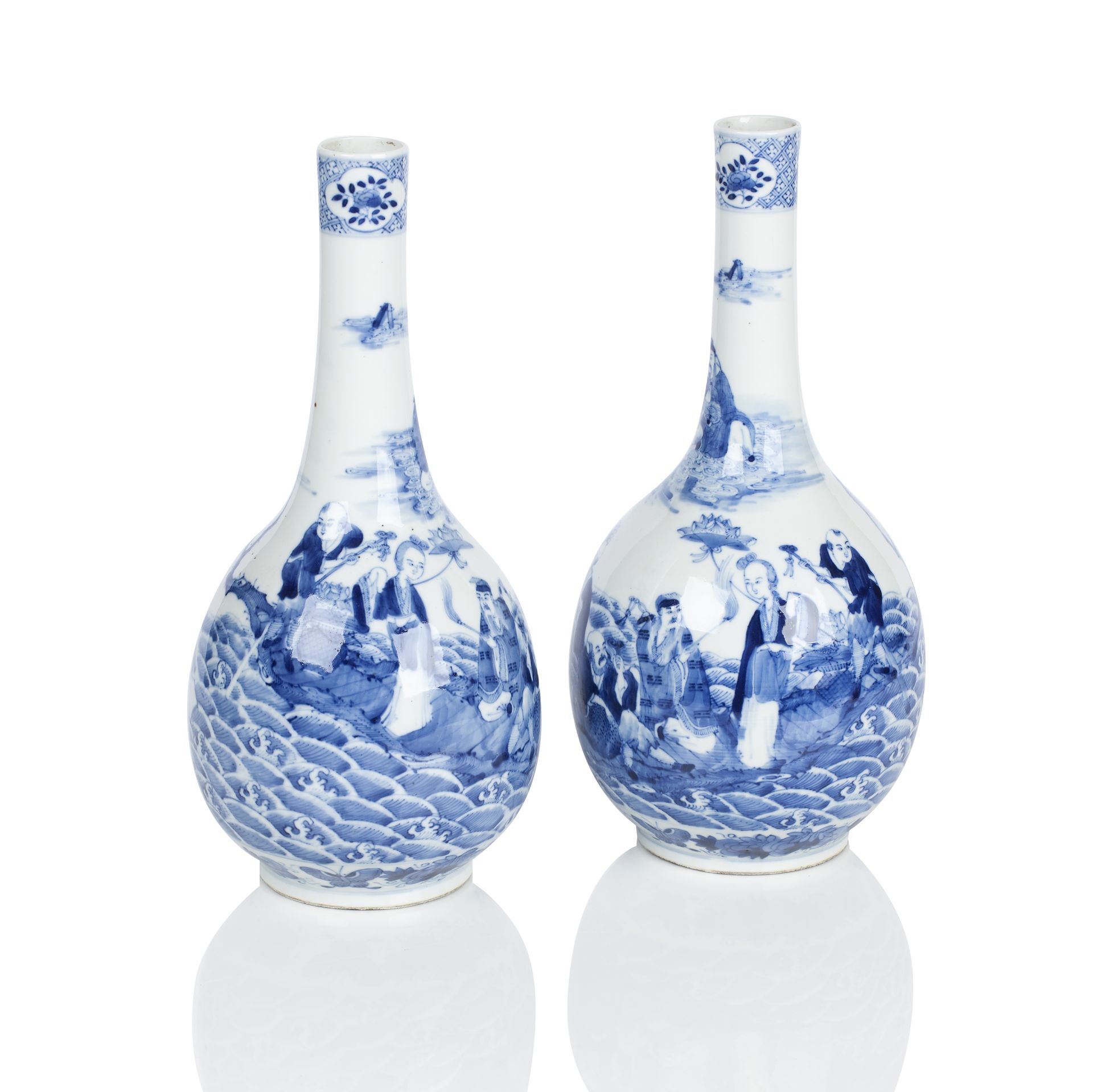 A pair of Kangxi style blue and white mirrored bottle vases Bearing four character marks but later,