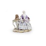 A Meissen group of a lady at a spinning wheel, late 19th century