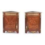 A pair of late 19th century mahogany marquetry inlaid gilt metal mounted bowfront corner cabinets...