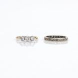 A diamond three-stone ring and an eternity ring