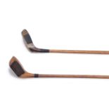 A GROUP OF WOODEN HEADED GOLF CLUBS WITH UNUSUAL FACES