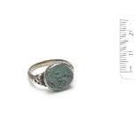 A green paste intaglio and silver ring, 19th century, or earlier