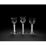 Three moulded opaque twist wine glasses, circa 1760-65
