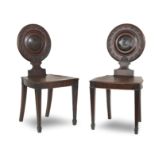 A pair of George III mahogany hall chairs