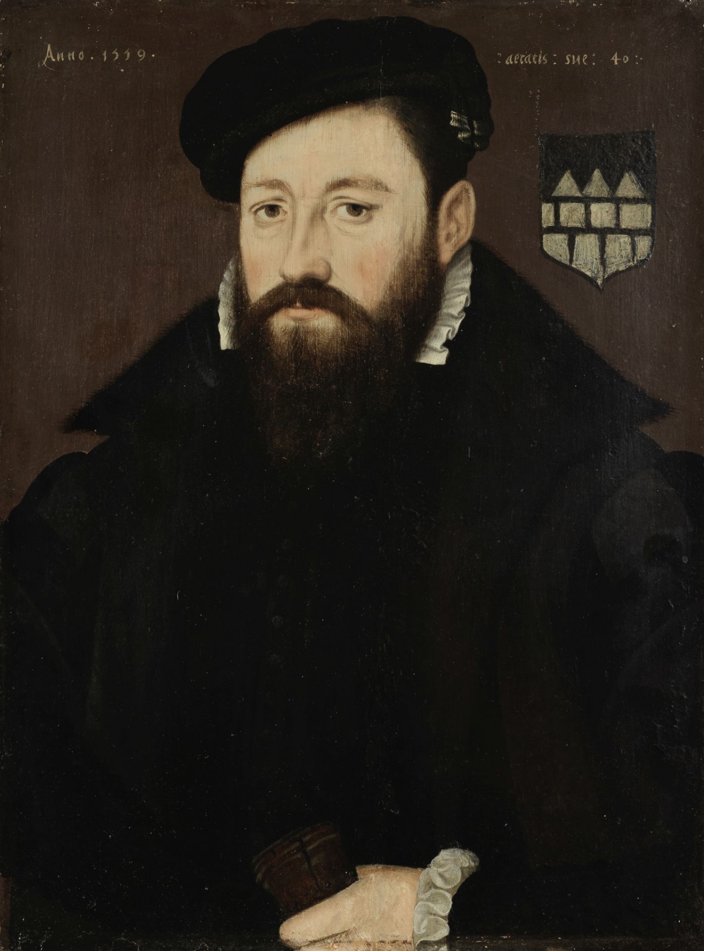 Netherlandish School, 16th Century Portrait of a gentleman, half-length, in black costume holding...