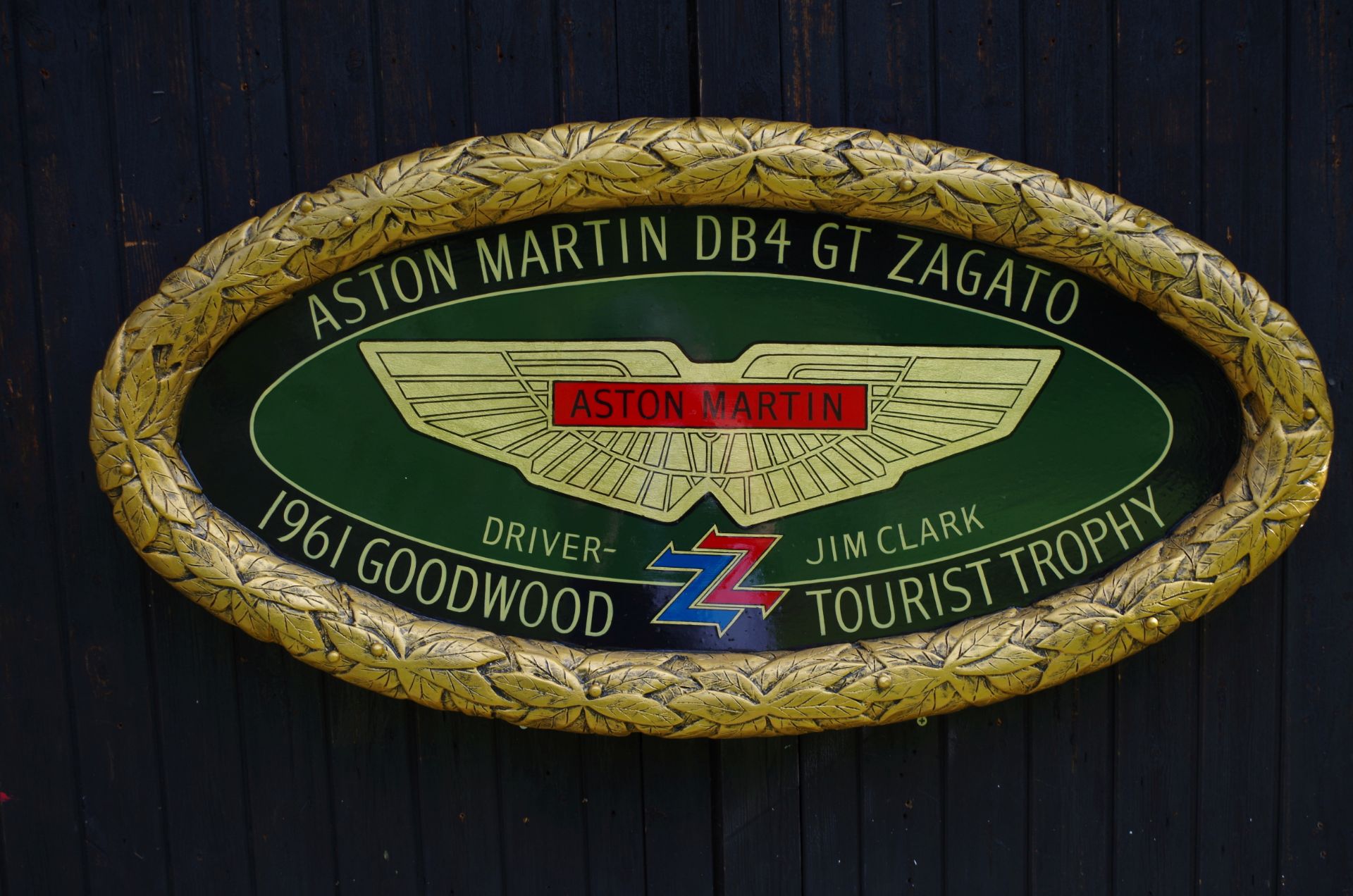 A hand-painted 'Aston Martin DB4 GT Zagato' celebratory oval plaque, ((2))