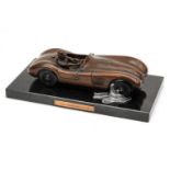 A BRONZE SCULPTURE OF JUAN MANUEL FANGIO IN THE JAGUAR C-TYPE, BY GARY SMITH (BRITISH 1961-),