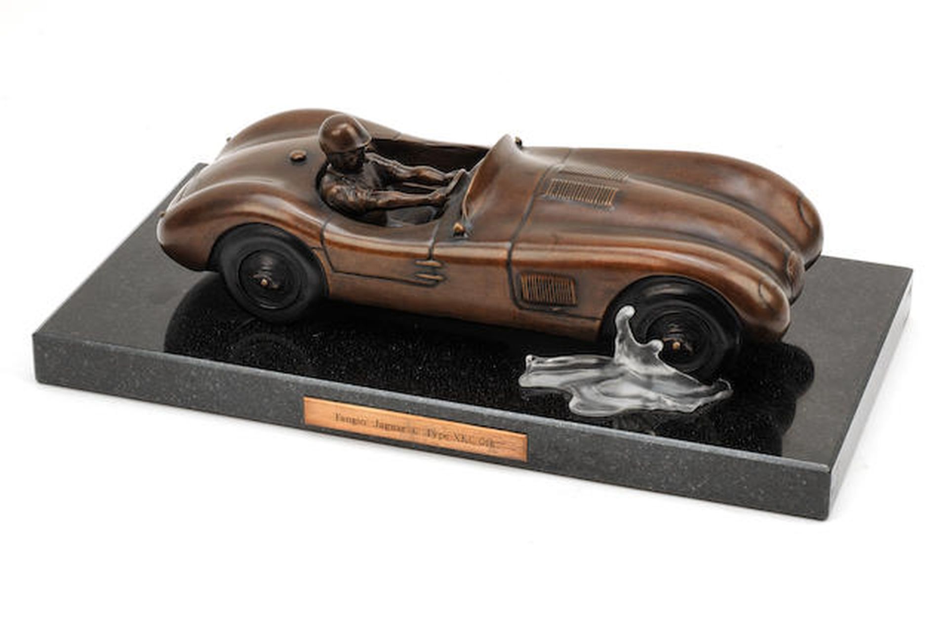 A BRONZE SCULPTURE OF JUAN MANUEL FANGIO IN THE JAGUAR C-TYPE, BY GARY SMITH (BRITISH 1961-),