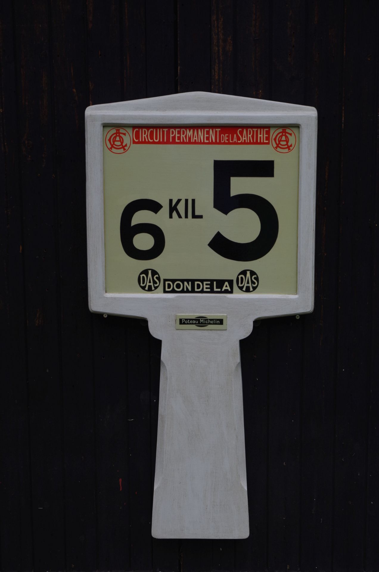 A hand-painted fibreglass reproduction Le Mans 24-hour race circuit kilometre marker board sign,