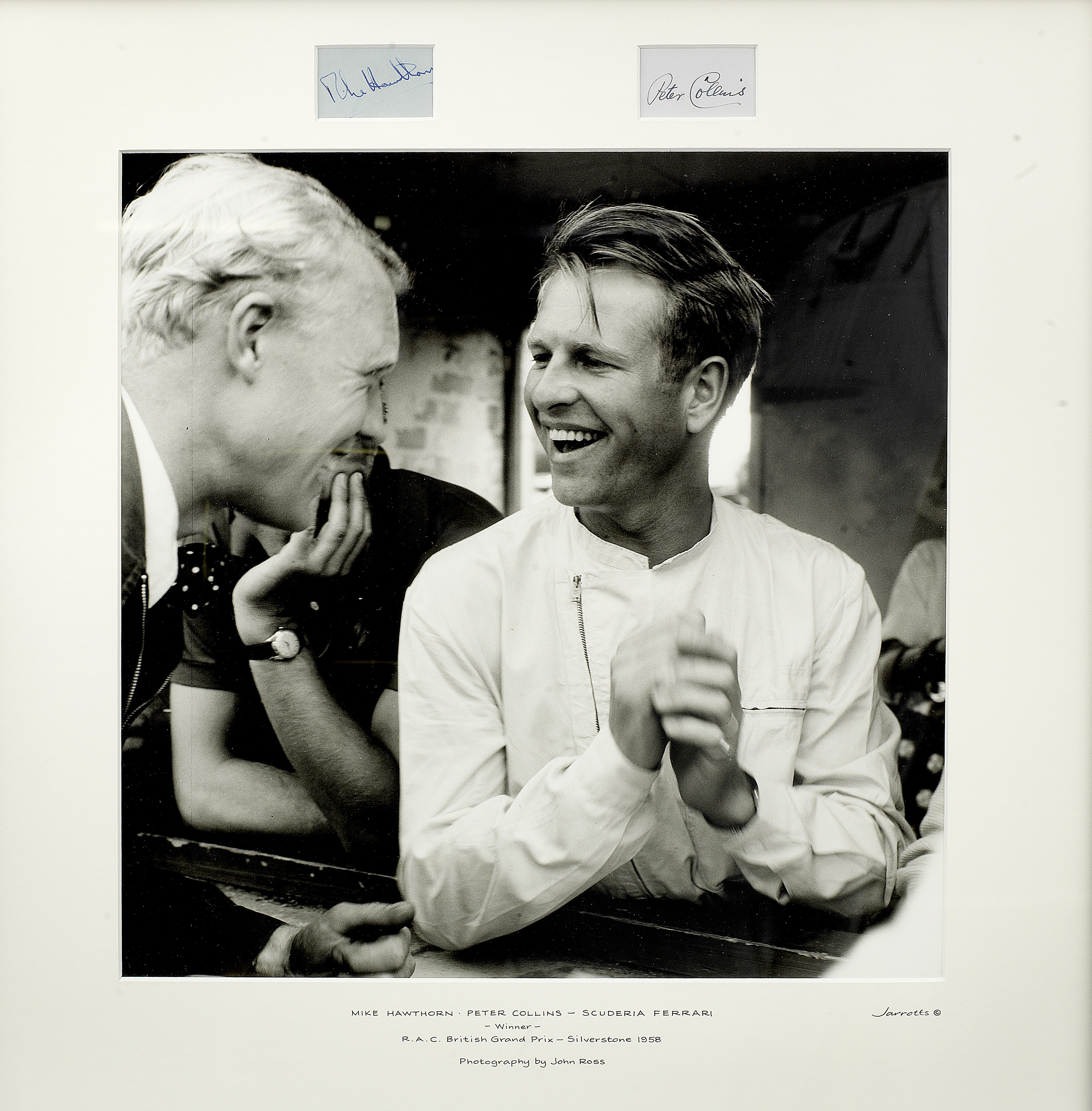 A framed photograph of Mike Hawthorn and Peter Collins with signatures,