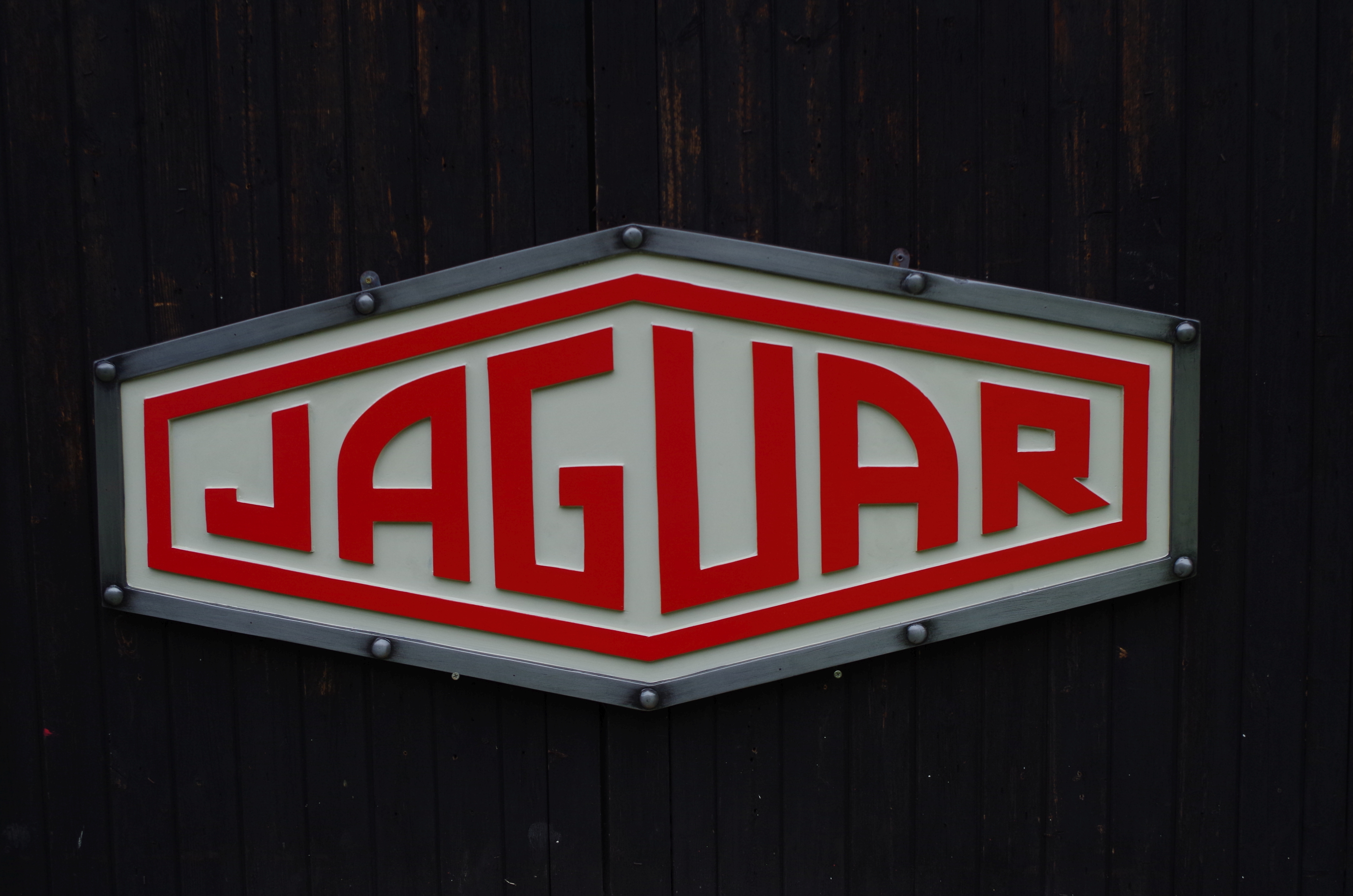 A cold cast 'Jaguar' garage display emblem,